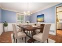 Inviting dining room with blue wallpaper, chandelier lighting, and a formal table setting at 1488 White Columns Blvd, Canton, GA 30115