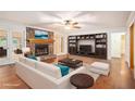 Bright living room featuring a stone fireplace, built-in shelves, and neutral furniture at 1488 White Columns Blvd, Canton, GA 30115