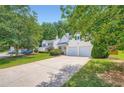 A two-story home features a lush green lawn and ample driveway space for parking at 181 Weatherstone Dr, Woodstock, GA 30188