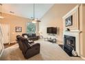 Spacious living room features a cozy fireplace, plush carpeting, and plenty of natural light at 181 Weatherstone Dr, Woodstock, GA 30188