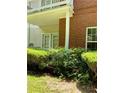 Exterior brick detail with a small, manicured yard and inviting walkout to green space at 1428 Orchard Park Dr, Stone Mountain, GA 30083