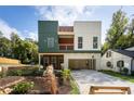 Contemporary home with two-car carport and modern siding next to landscaped yard at 2312 Herring Sw Rd, Atlanta, GA 30311
