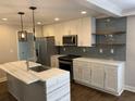 Bright kitchen with a marble island, stainless steel appliances, and modern fixtures at 2625 Semmes St, Atlanta, GA 30344