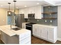 Modern kitchen features stainless steel appliances, white cabinets, and a marble countertop island at 2625 Semmes St, Atlanta, GA 30344