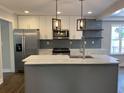 Bright kitchen with a marble island, stainless steel appliances, and modern lighting at 2625 Semmes St, Atlanta, GA 30344
