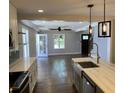 Open concept view from the kitchen to the living room with hardwood floors and modern design at 2625 Semmes St, Atlanta, GA 30344