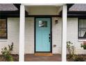 Close-up of the entryway featuring a light blue front door and 'Welcome' mat at 1218 Crestwood Se Dr, Atlanta, GA 30316