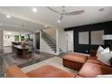 Open concept living space featuring a modern sectional sofa, dining area, and staircase at 1218 Crestwood Se Dr, Atlanta, GA 30316