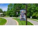 Community signage featuring manicured landscaping, decorative lighting, and banner for Soleil Belmont Park at 309 Brooke View Trail, Canton, GA 30115