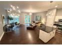 Bright, open-concept living space featuring modern lighting, a desk area, and seamless kitchen access at 560 Dutch Valley Road # 2412, Atlanta, GA 30324