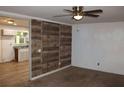 Inviting living area with wood accent wall, a ceiling fan, and seamless transition to kitchen at 8469 Shiloh Ct, Jonesboro, GA 30238