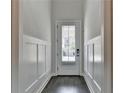Bright entryway with paneled walls and a wood floor, creating a welcoming first impression at 1045 Penny Ln, Roswell, GA 30076