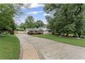 Spacious front yard featuring a long driveway and well-maintained landscaping at 2737 Fontainebleau Drive, Dunwoody, GA 30360