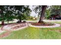 Landscaped front yard featuring decorative stone and mature trees at 2737 Fontainebleau Drive, Dunwoody, GA 30360