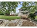 Charming two-story home featuring a lush lawn and brick walkway at 2737 Fontainebleau Drive, Dunwoody, GA 30360
