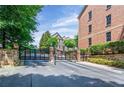 Wrought iron gate at the entrance to a beautiful community with brick pillars and greenery at 2873 Overlook Ne Way, Atlanta, GA 30324
