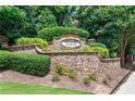 Stone monument sign for Overlook at Lenox community with lush landscaping and mature trees at 2873 Overlook Ne Way, Atlanta, GA 30324