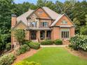Charming two-story home with a beautifully landscaped front yard and inviting front porch at 908 Basingstoke Ct, Suwanee, GA 30024
