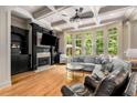 Spacious living room with hardwood floors, fireplace, built-ins and large windows at 908 Basingstoke Ct, Suwanee, GA 30024