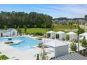 Community pool with cabanas and lounge chairs, perfect for relaxation and recreation at 314 Brooke View Trail, Canton, GA 30115