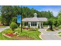 Inviting gated community entrance with manicured landscaping and a welcoming guardhouse at 314 Brooke View Trail, Canton, GA 30115