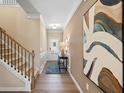 Bright hallway featuring hardwood floors, wainscoting, and an elegant staircase at 22 Jacobs Farm Ln # 11, Lawrenceville, GA 30045