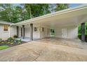 Spacious covered carport featuring brick and post supports leading to a side entrance at 3222 Edgemont Way, Decatur, GA 30032