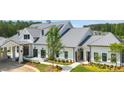 Elegant community clubhouse with white siding, metal roof, and meticulously maintained grounds at 327 Brooke View Trail, Canton, GA 30115