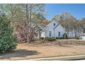 Front lawn view of the home with stone accents and a well-manicured garden at 3619 Elinburg Ne Ct, Buford, GA 30519