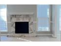 Living room featuring a stone fireplace, with neutral walls, and bright windows at 4465 Kent Rd, Atlanta, GA 30337