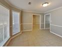 Bright living room featuring neutral tile flooring, fresh paint, and natural light from a bright window at 4465 Kent Rd, Atlanta, GA 30337