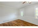 Inviting room with hardwood floors, decorative wall trim, and a bright window creating a cozy, stylish space at 49 Sweetwater Ct, Powder Springs, GA 30127