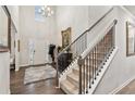 Grand foyer featuring a staircase, hardwood floors, a decorative rug, and an elegant chandelier at 4365 Sunflower Cir, Cumming, GA 30040