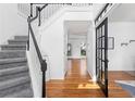 Elegant foyer with hardwood floors and a staircase, leading to other rooms at 1612 Branch Creek Cv, Lawrenceville, GA 30043