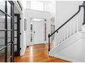 Bright and airy foyer with hardwood floors and staircase at 1612 Branch Creek Cv, Lawrenceville, GA 30043