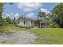 Inviting home exterior with a cozy covered porch, complemented by vibrant flowers and a well-maintained lawn at 3411 Morgan Rd, Canton, GA 30115