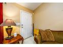 Entryway features a white front door, side table with lamp, and cozy seating area at 455 Lakeside Cir, Covington, GA 30016