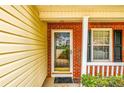 Close-up view of the front porch with brick accents, a glass door, and a neatly kept welcome mat at 455 Lakeside Cir, Covington, GA 30016