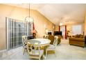 Inviting living room and dining area with vaulted ceilings, neutral tones, and a view of the fireplace at 455 Lakeside Cir, Covington, GA 30016