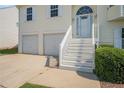 Home with a two-car garage, front steps, and manicured landscaping at 7835 Teton Trl, Douglasville, GA 30134