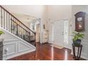 Bright foyer featuring hardwood floors, high ceilings, a staircase, and natural light at 122 Susobell Pl, Woodstock, GA 30188