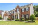 Charming two-story brick house with well-maintained landscaping, black shutters, and light trim at 122 Susobell Pl, Woodstock, GA 30188