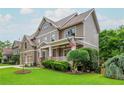 Charming home featuring a well-maintained lawn and lush landscaping with an inviting covered porch at 2850 Seagrave Way, Marietta, GA 30066