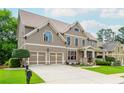 Traditional home with a two-car garage, well-kept lawn, and inviting covered front porch at 2850 Seagrave Way, Marietta, GA 30066