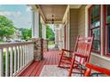 Inviting front porch with a red rocking chair, stone accents, and painted floors at 2850 Seagrave Way, Marietta, GA 30066