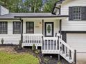 Close up of home's entrance featuring a stylish front porch and freshly painted siding at 3232 Valley View St, Powder Springs, GA 30127