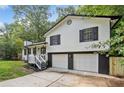 Exterior view of a home with white siding and a black roof and shutters at 3232 Valley View St, Powder Springs, GA 30127