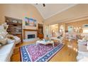 Elegant living room with fireplace, hardwood floors, and vaulted ceilings at 390 Glengarry Chase, Covington, GA 30014