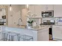 Bright kitchen with granite countertops, stainless steel appliances, modern fixtures, and breakfast bar at 404 Satilla Ct, Locust Grove, GA 30248