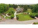 Aerial view of the property featuring a beautiful lakeside home with circular drive at 794 Rutland Ct, Lithonia, GA 30058